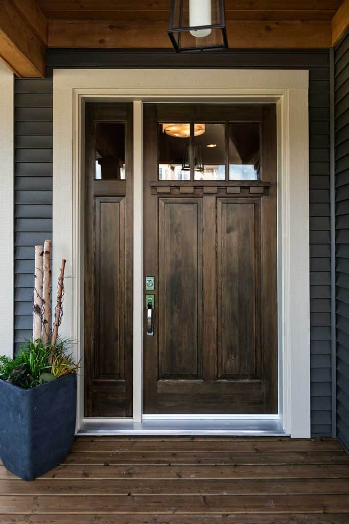 Front entrance of a home with wooden floor and wooden door
