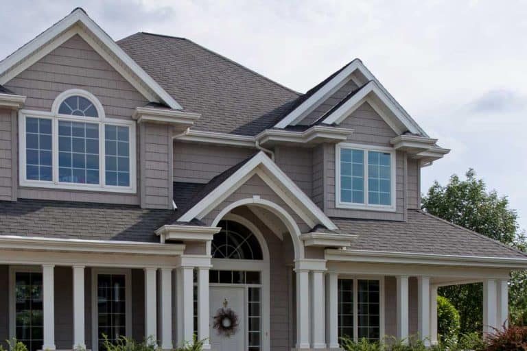 Front of a beautiful luxury home in a typical suburban neighborhood, What Color Trim Goes With A Gray House?