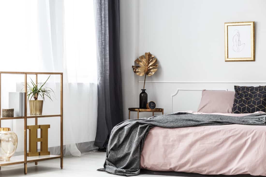 Gold leaf in bedroom, gold colored furniture in gray and pink bedroom with a dash of gold touch