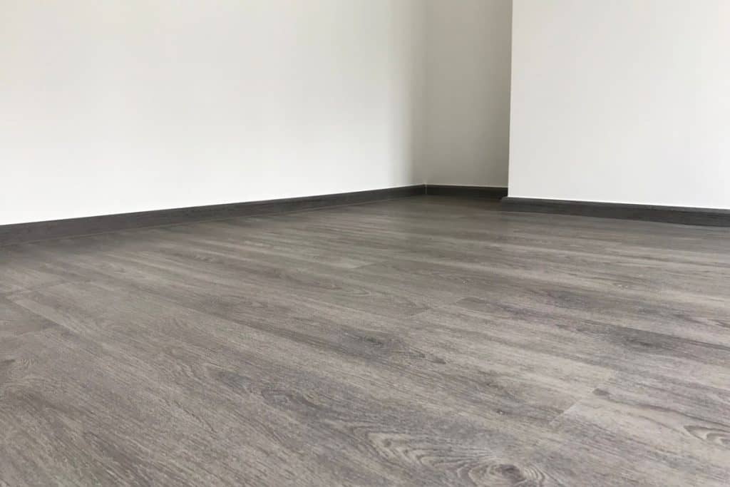 Gray vinyl flooring inside an empty living room