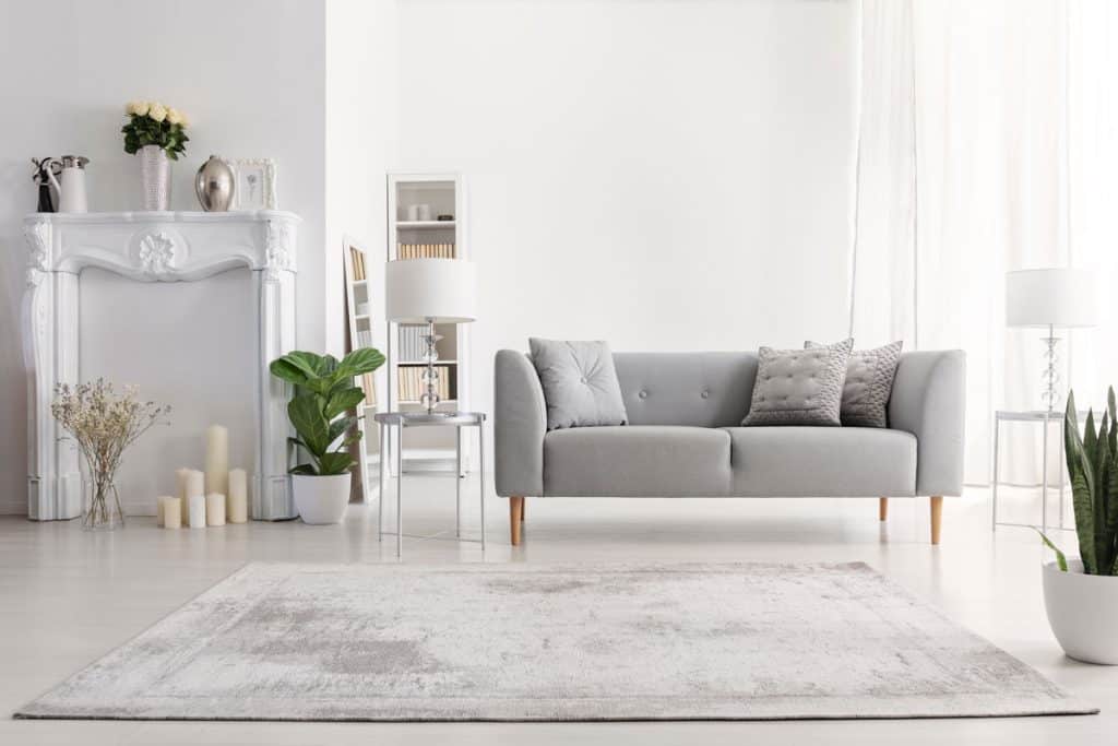 Grey sofa and matching grey carpet inside a modern living room