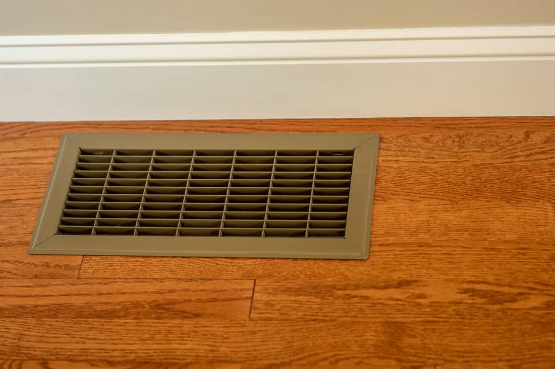 Home renovation finished with hvac cooling system central air installed using floor vent in wood floors 