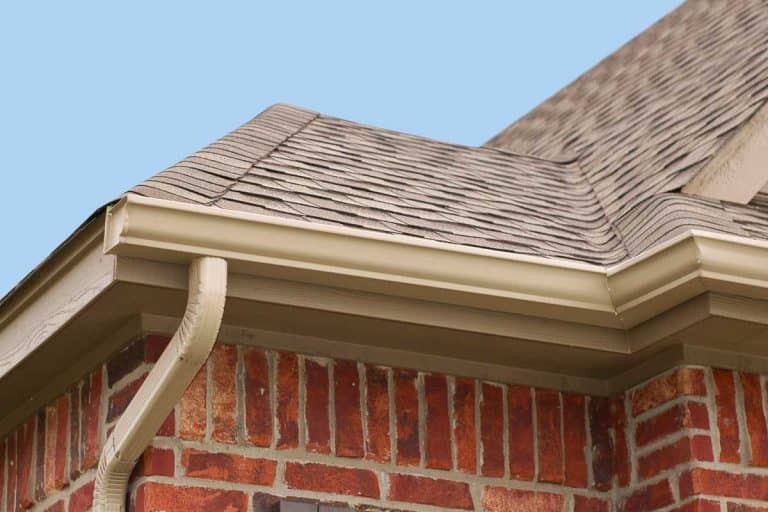 House roof, gutters and downspout on the corner of a house, What Color Gutters For Brick House?
