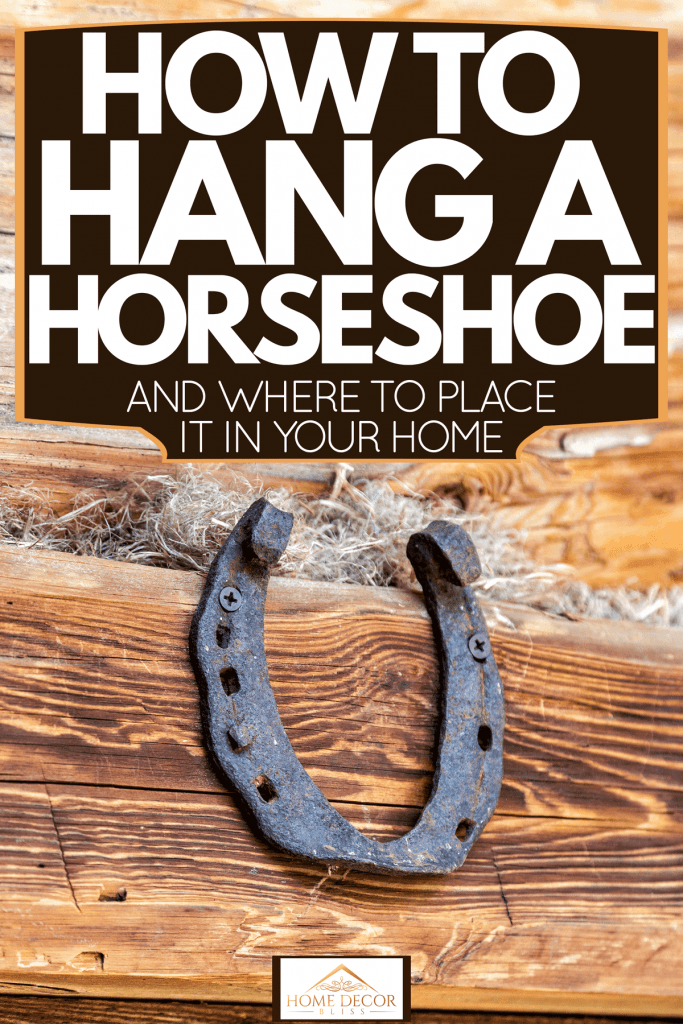 A rusted out horseshoe screwed up on a wooden wall, How To Hang A Horseshoe [And Where To Place It In Your Home]