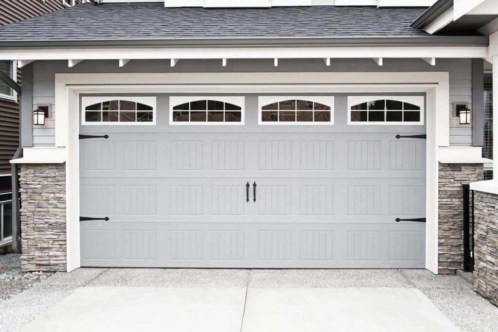 Light gray classic garage door with arched windows