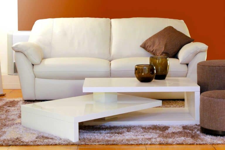 Living room with white sofa, brown pouf and white coffee table, How To Whiten Yellowed Leather Sofa [7 Steps]