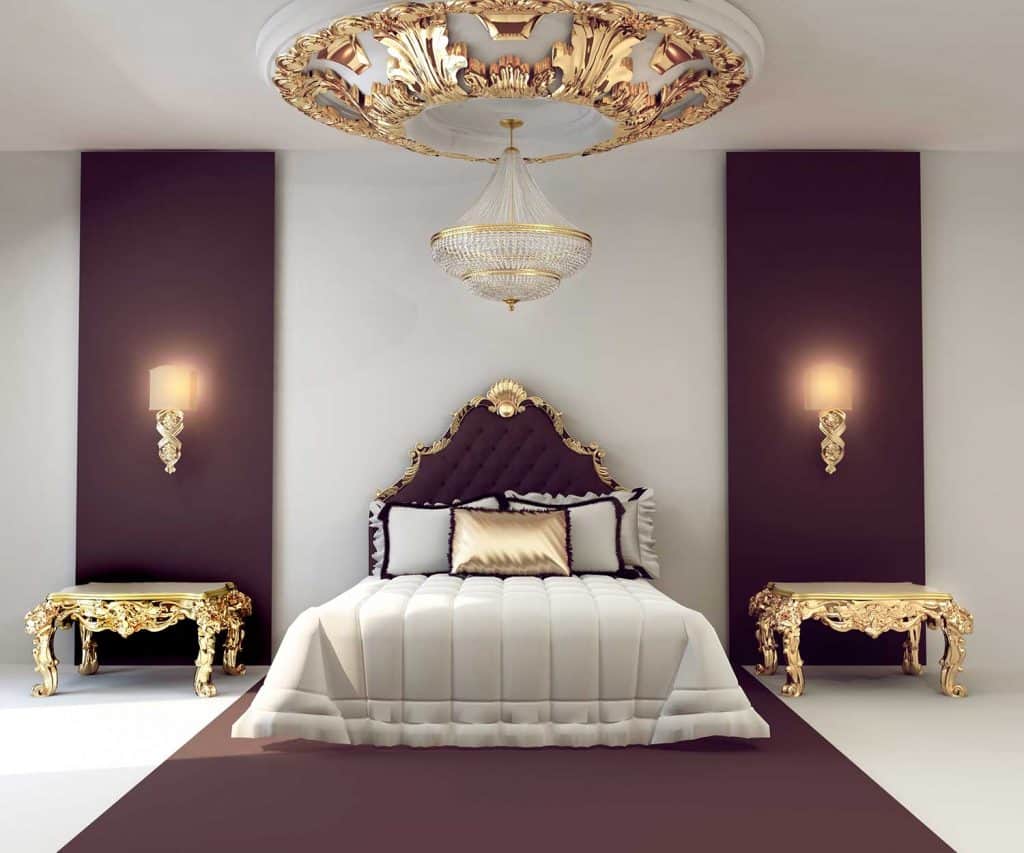 Luxury double bedroom with golden furniture in royal interior