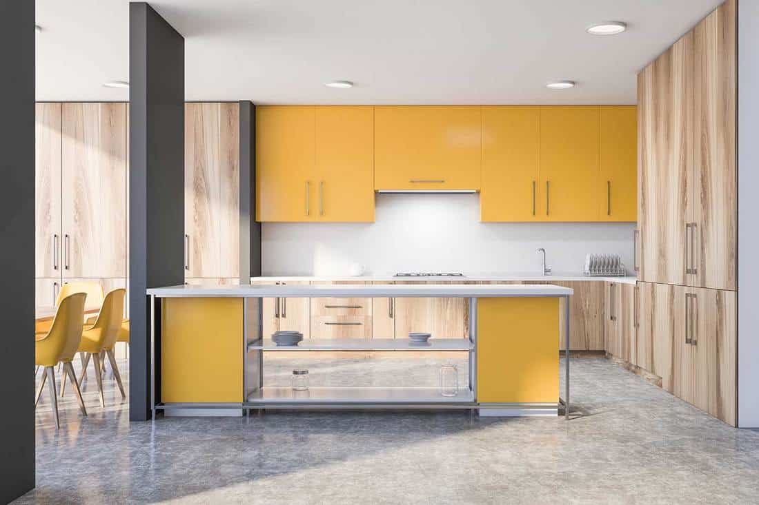Modern kitchen interior with island, yellow and wooden cabinets