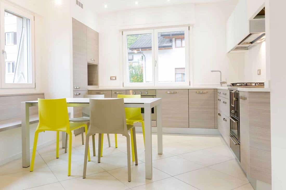 Modern kitchen interior with white walls and tiled floor