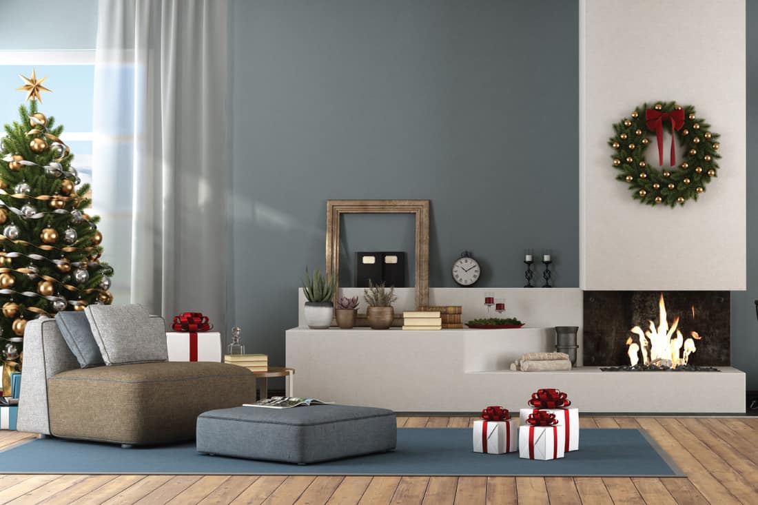 Modern living room with Christmas tree and fireplace. blue carpet and tan couch. What Color Couch Goes With Blue Carpet [7 Excellent Colors]