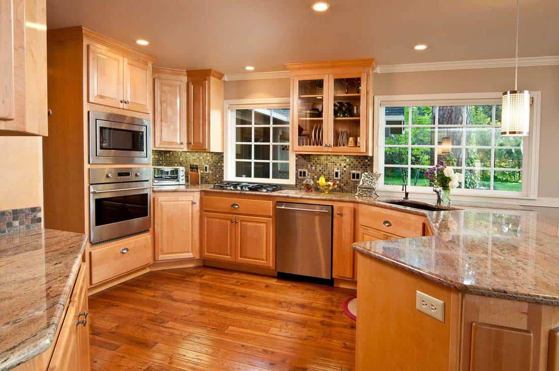 Modern, spacious kitchen with hardwood floors and cabinets