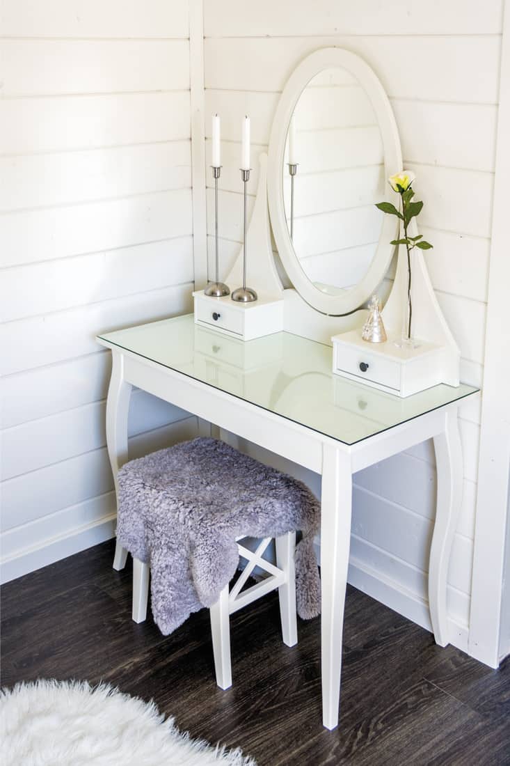 Old fashion vanity table in bedroom, corner seat style dresser