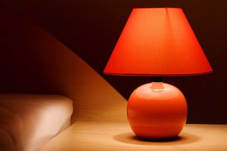 Orange bedside lamp on a bedside table, 25 Types Of Lampshades