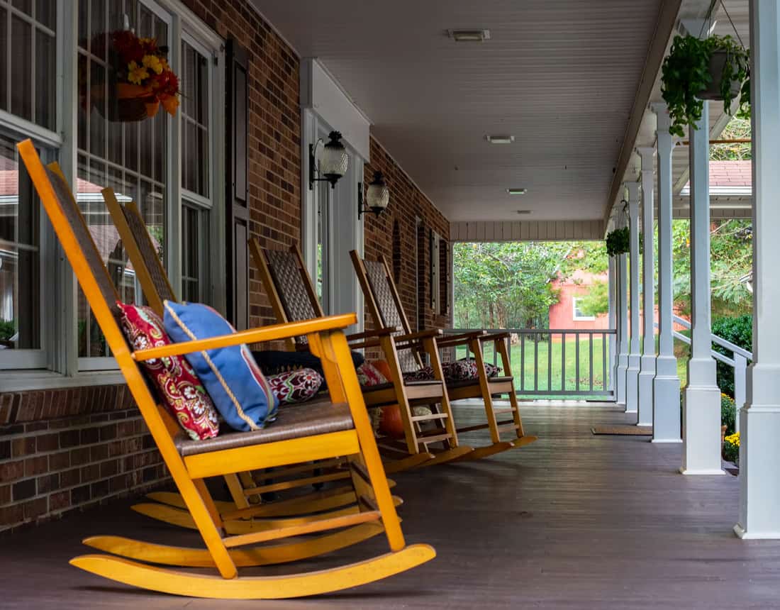 Wooden rocking chair on front porch at sunset nobody
