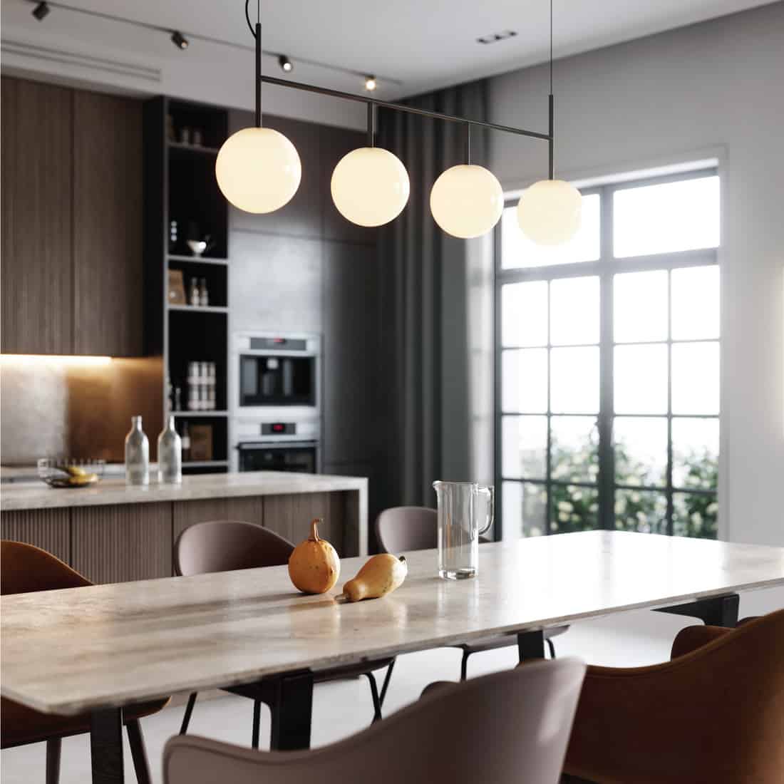 Sleek Kitchen With Warm Colors. globe lights hanging above the dining table