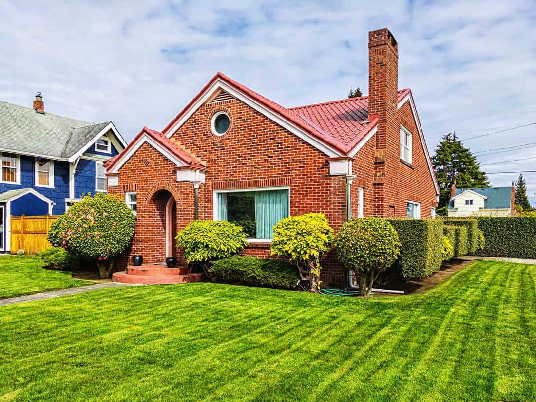 Small American red brick home on a sunny day