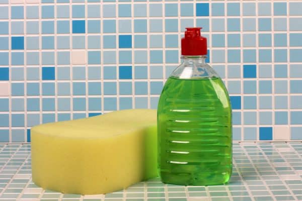 Soap and cleaning products on tile background