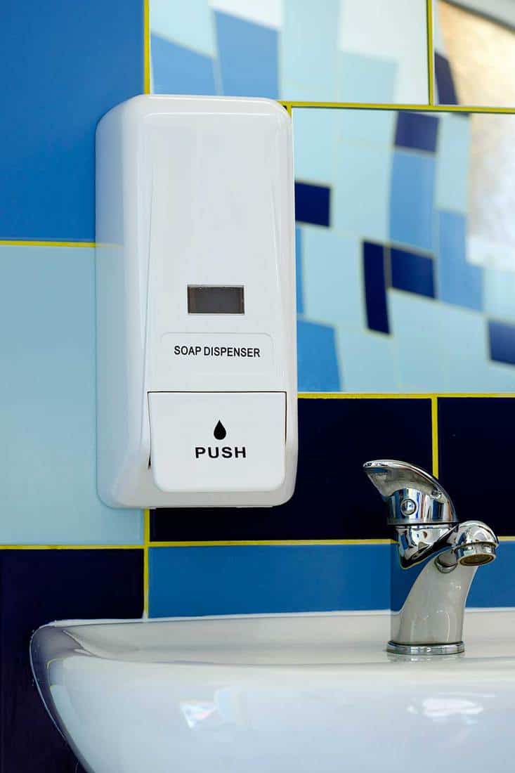 Soap dispenser over bathroom sink