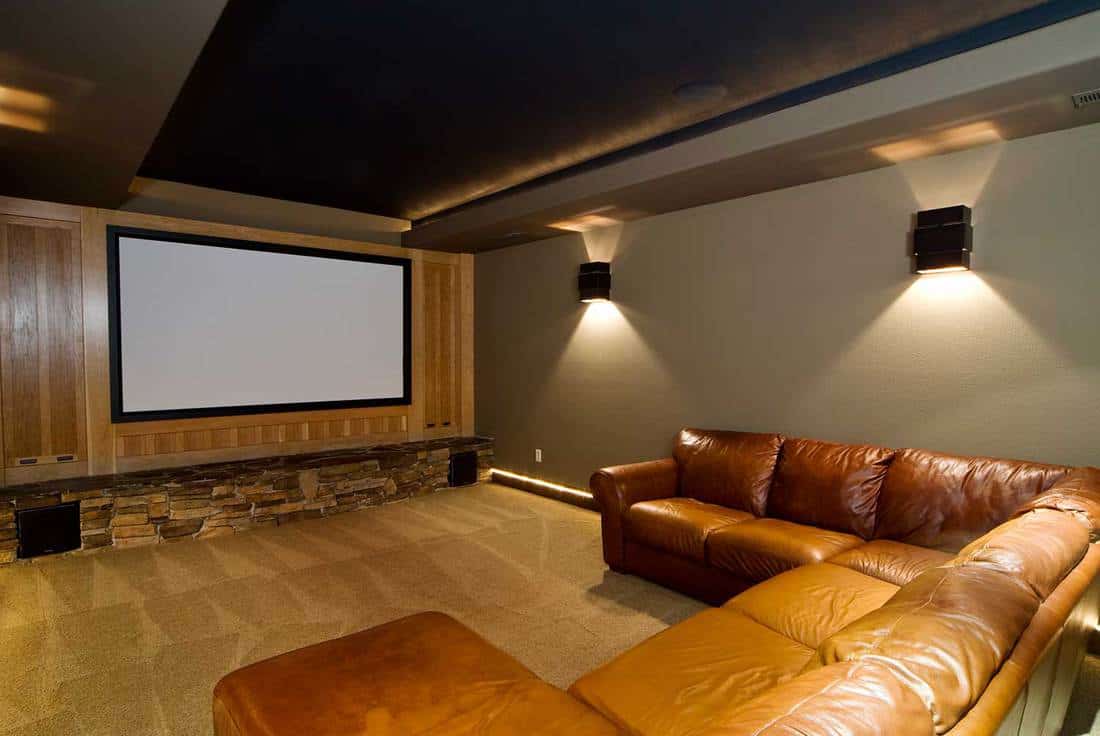 Theater room with large cushion U shape sofa