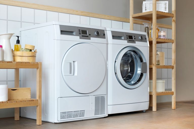 Two white duet dryers inside a laundry room, Two white duet dryers inside a laundry room