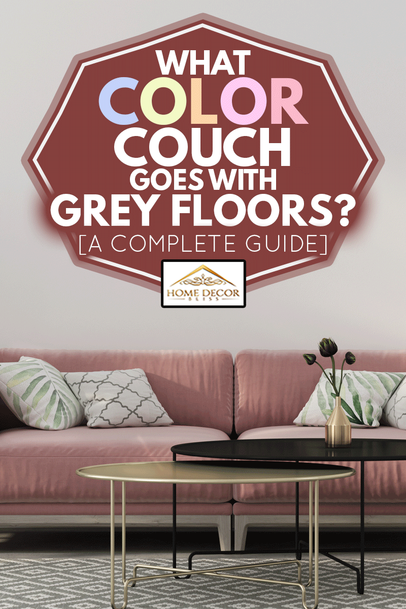 Stylish living room interior in pink with a concrete floor, velvet sofa, wicker chair, golden table, chandeliers and tropical plants in grey floors, What Color Couch Goes With Grey Floors? [A Complete Guide]