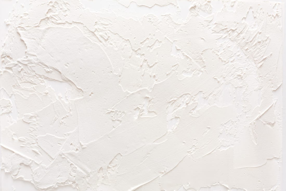 White wall with plaster pattern skip troweling