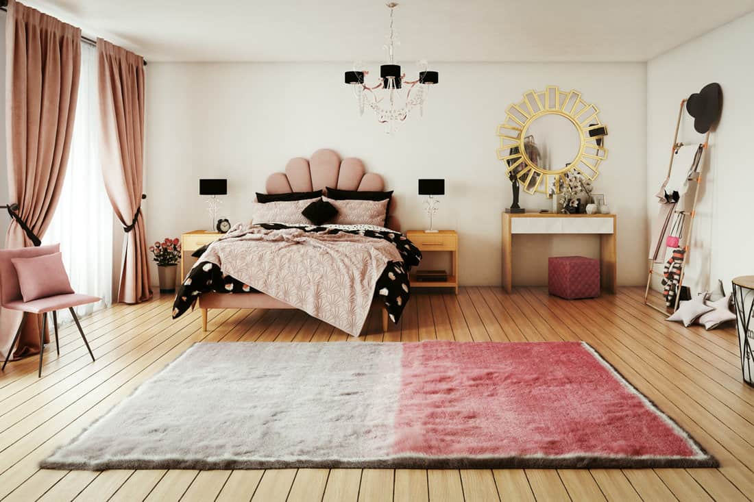 Wooden flooring matched with a red and white rug