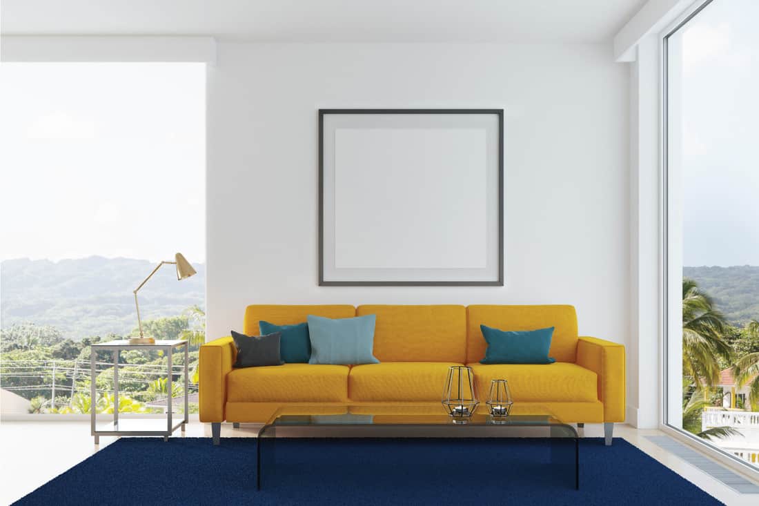 Yellow sofa, blue and green pillows living room. Bold Yellow Sofa With Blue Carpet