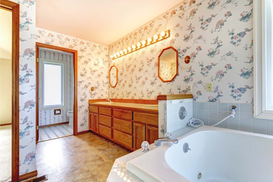 bathroom interior with bright wallpaper, wooden elements. How To Wallpaper Around Bathroom Fixtures