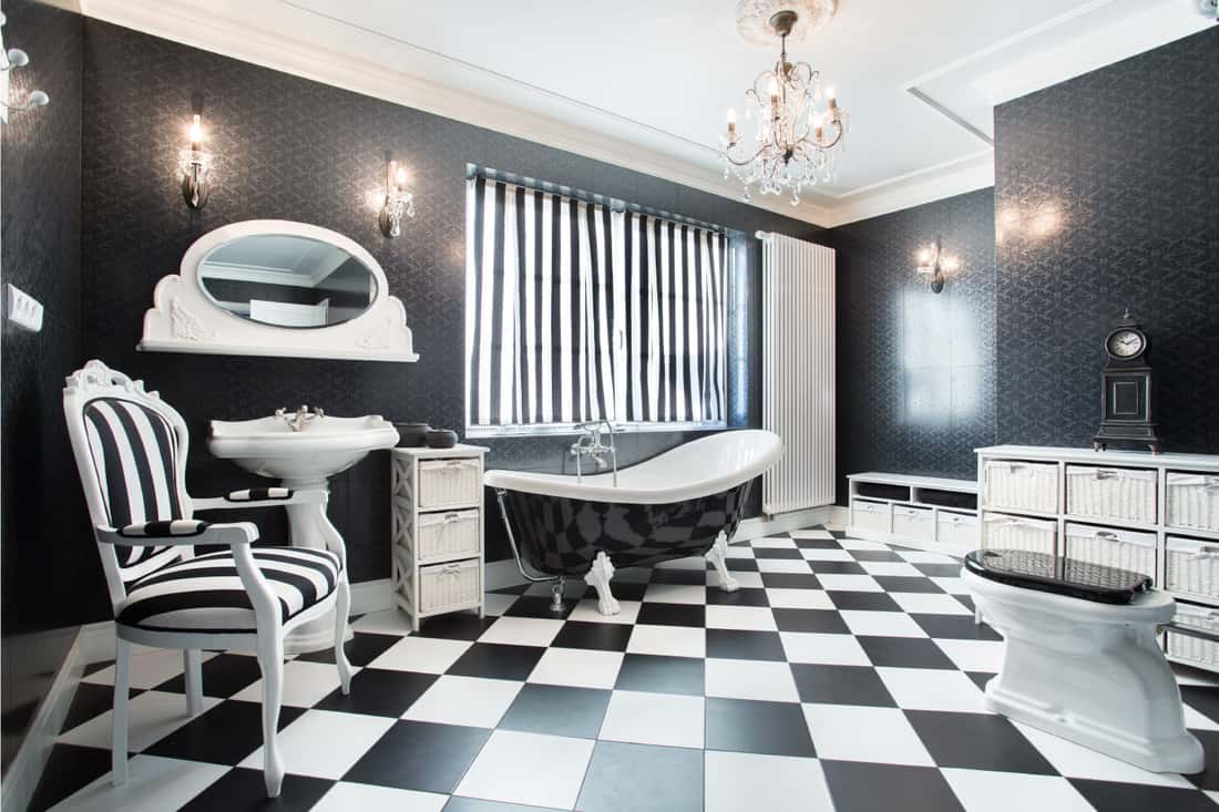 black and white wallpaper in a modern bathroom with bathtub and vanity mirror