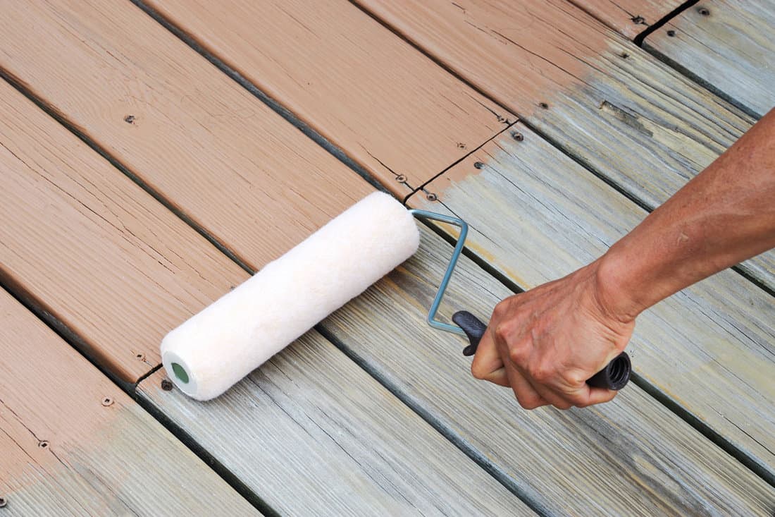 close on handyman painting old deck