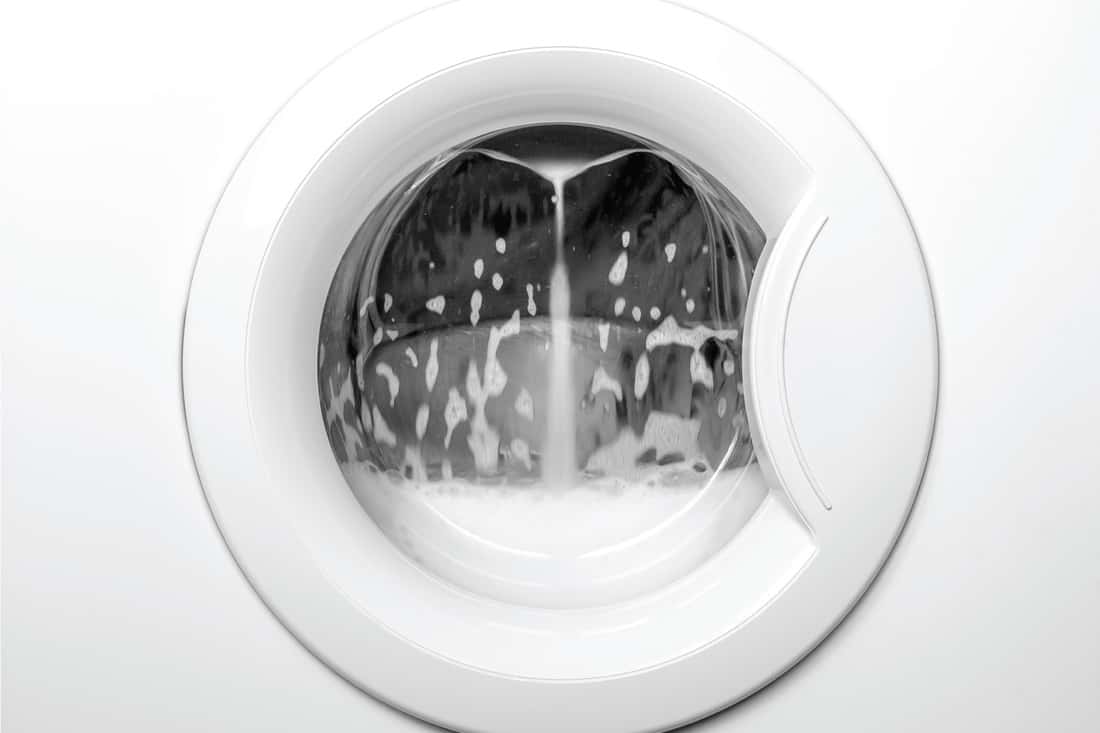 close up photo of a white washin machine while in operation