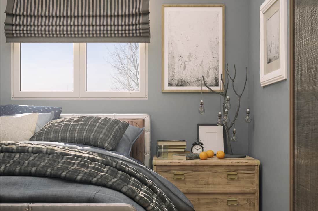 Cozy tiny bedroom with blue and gray walls, bedding, and Pinstripe Roman Shades