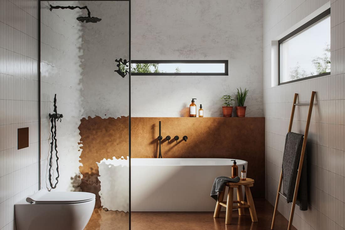 image of a domestic bathroom interior with toilet and bathtub, Can You Put Bathroom Wall Panels Over Tiles?