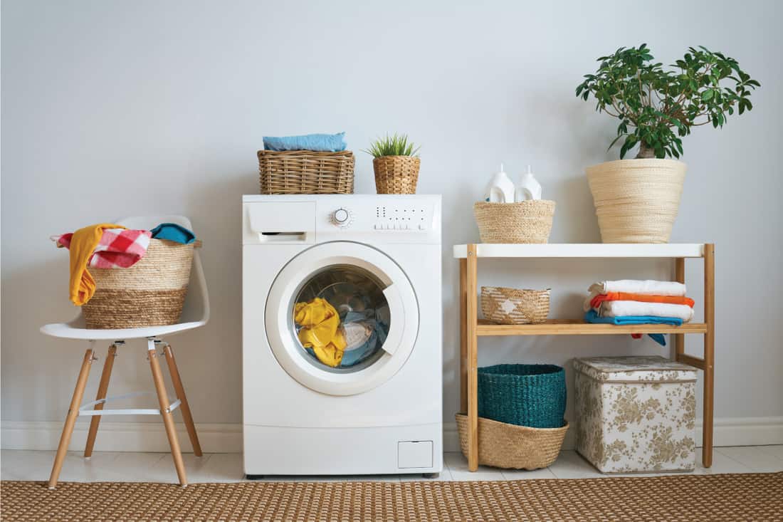 laundry room with washing machine, wicker basket, brown rug. Samsung Washer Won't Drain - What To Do