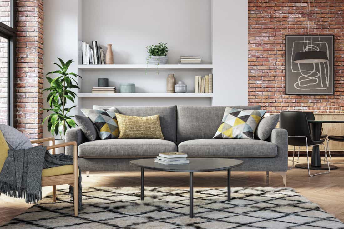 Living room with gray and yellow colored furniture and wooden elements, How To Hang Stuff Up Without Wall Space [4 Ways]