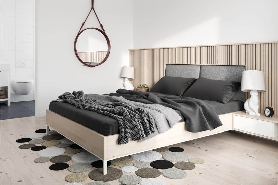 Modern bedroom with white bed frame, gray beddings and wood panels wall design