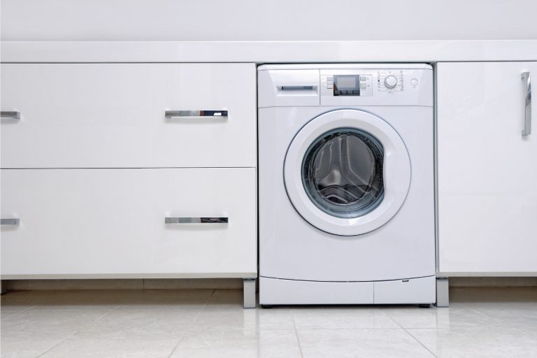 washer within cabinets in a modern home. How Much Does A Washer Weigh [A Complete Guide]