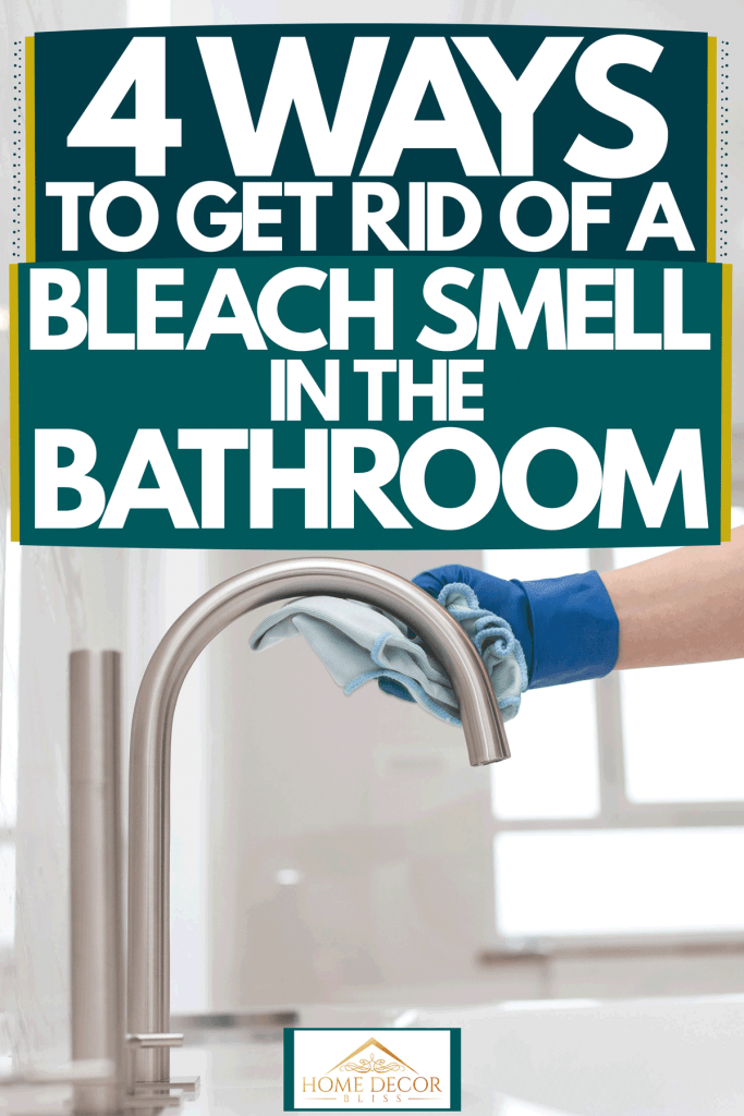 A woman wearing gloves and cleaning her modern bathroom, 4 Ways To Get Rid Of A Bleach Smell In The Bathroom