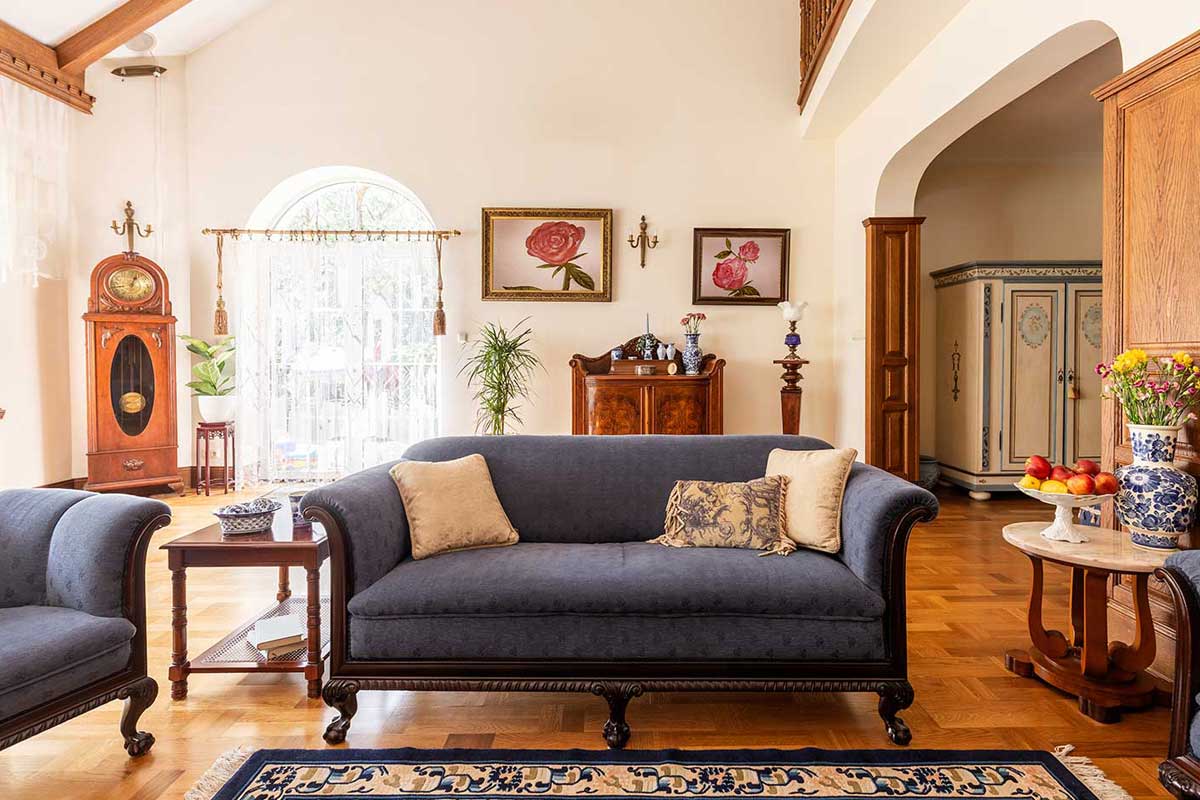 A cobalt blue sofa and other antique furniture on a wooden floor in a spacious living room interior of a classic mansion, 28 Furniture Styles You Should Know