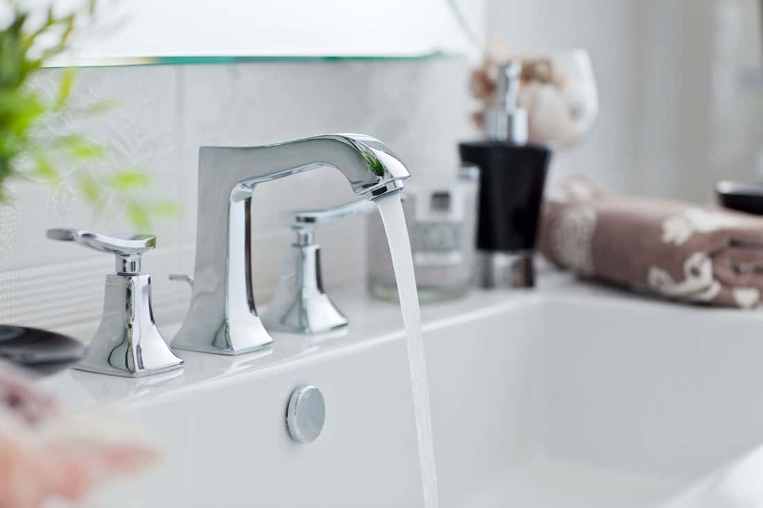 A faucet turn on inside a modern bathroom, Is Bathroom Sink Water Safe To Drink?