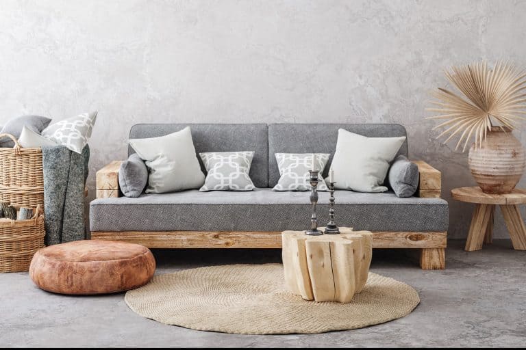 A gorgeous boho inspired living room with a gray faux wall and boho themed furniture's, 5 Questions To Ask Yourself When Choosing Wallpaper For The Living Room