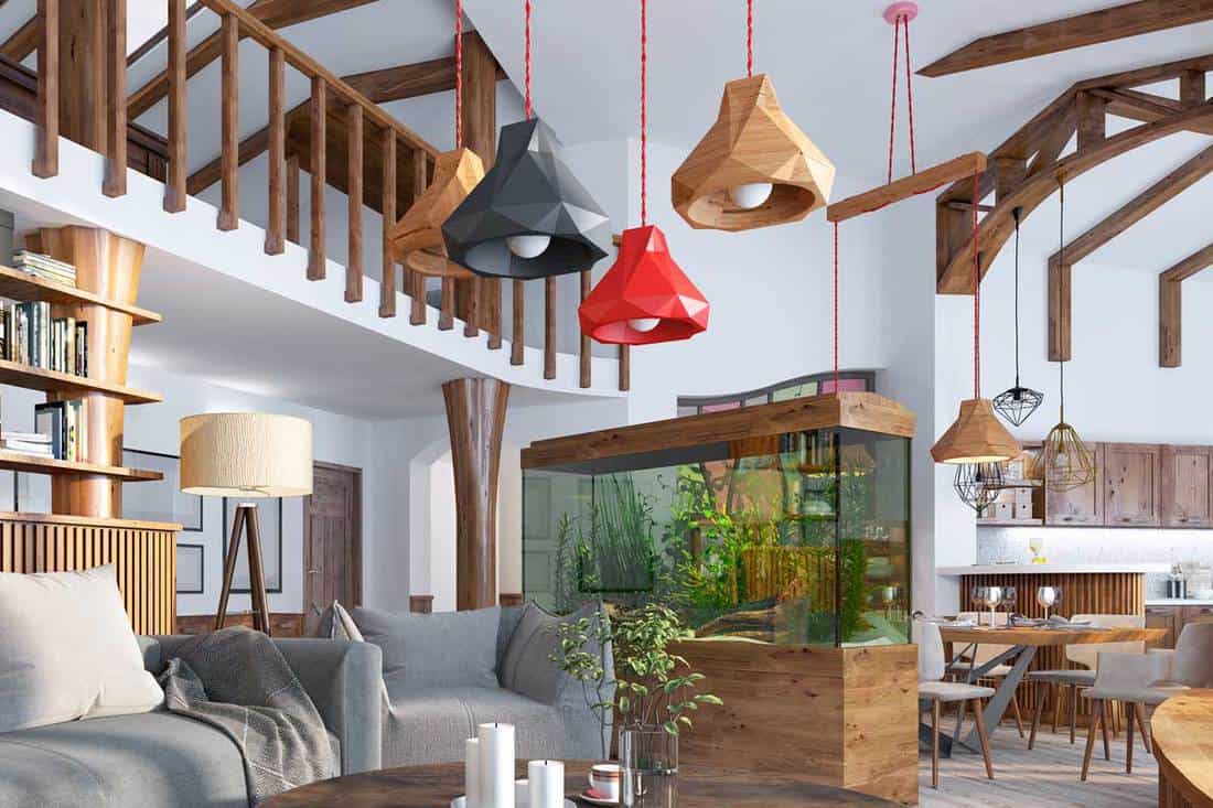 A loft style rustic living room with aquarium and stylized shelving for books, 11 Awesome Rustic Ceiling Lighting Ideas