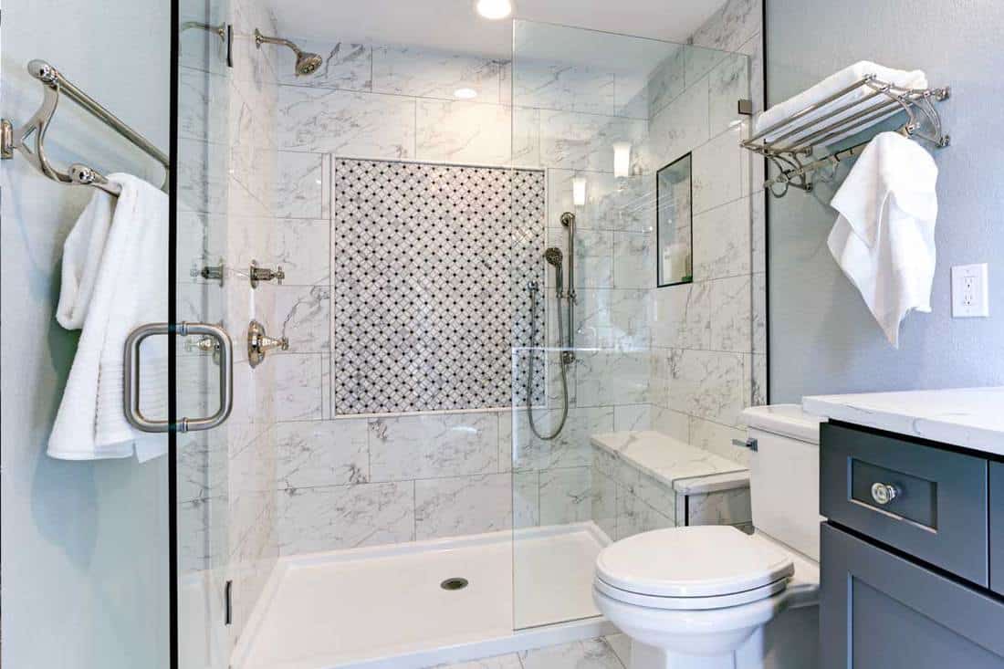 A new blue bathroom design with marble shower surround and mosaic accent tiles, Is A Shower Base Better Than Tiles?