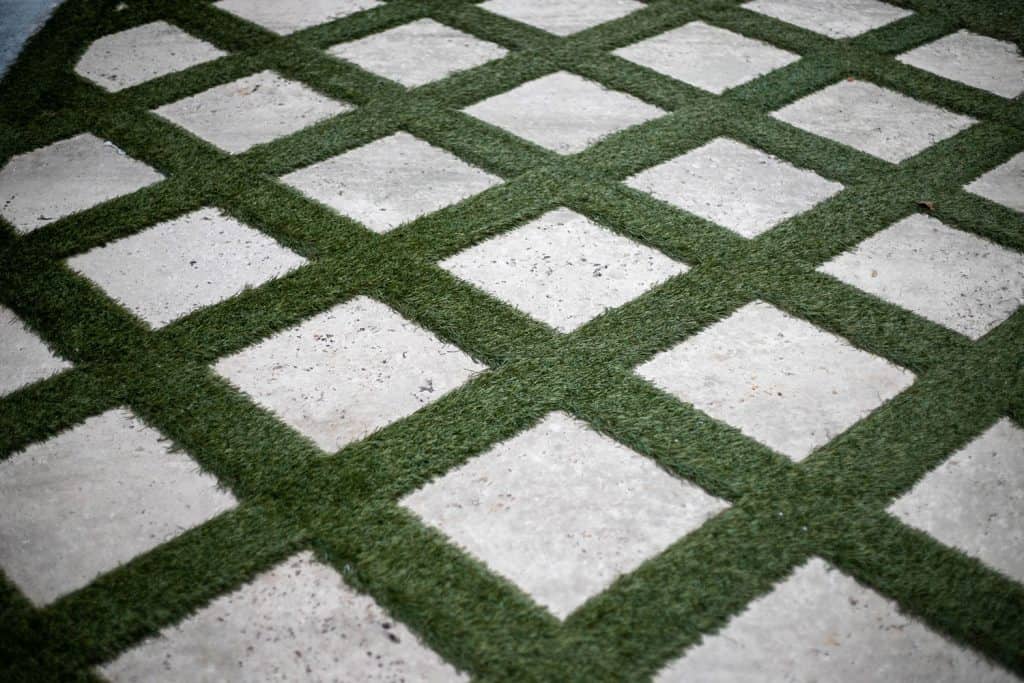 A paver design with Bermuda grass on the sides