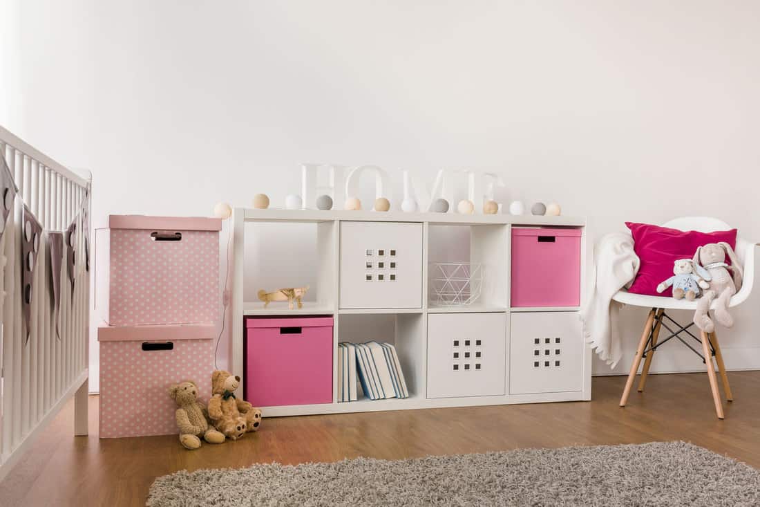 A small white sideboard with different pink colored containers, Sideboard Vs Buffet Vs Credenza - Everything You Need To Know