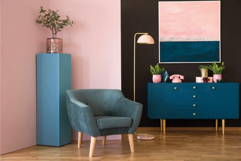 Blue suede armchair against pink wall in living room interior with cabinet under painting. 11 Blue And Pink Living Room Ideas You Need To See