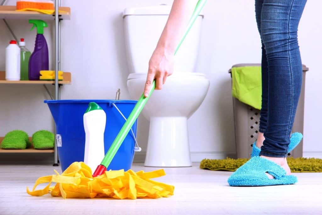 Cleaning the bathroom floor with a mop