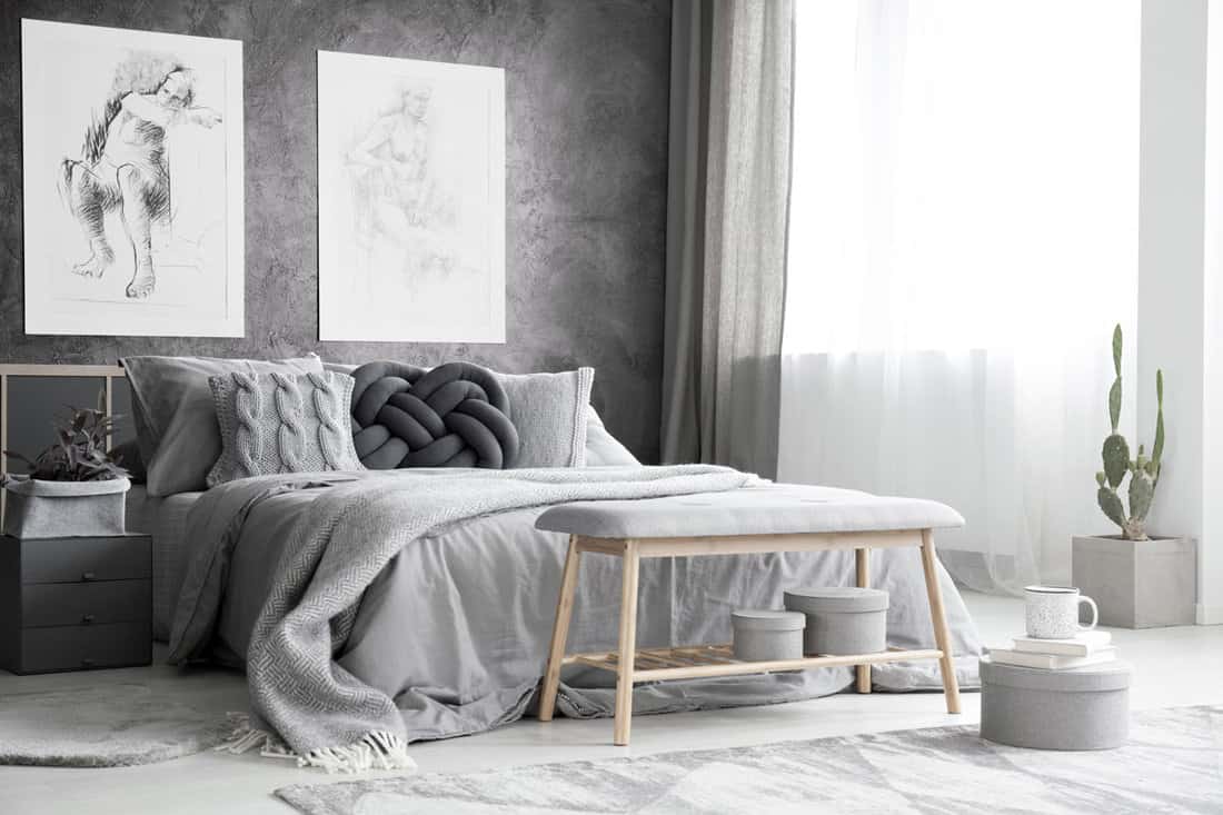 Gray beddings and matching gray pillows inside a gray themed bedroom