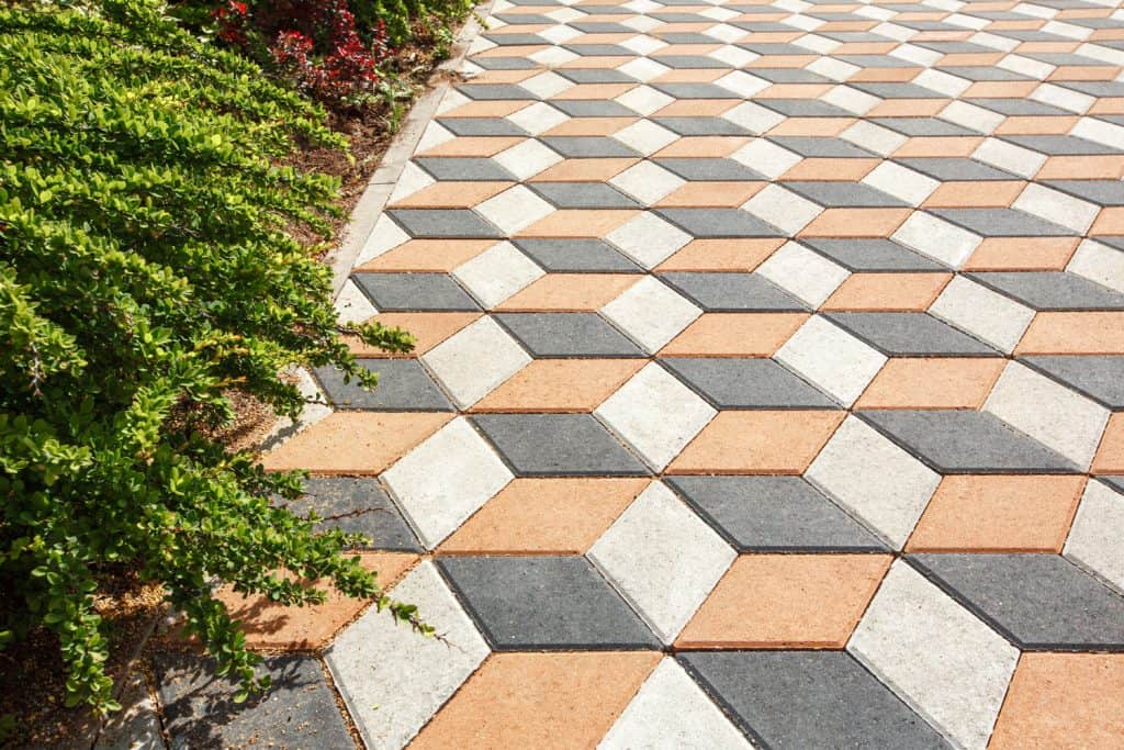 Hexagonal designed tiled driveway with gray, white, and orange design